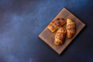 Delicious homemade pastries with apricot jam sprinkled with sesame seeds photo