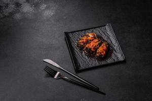 Dolma, stuffed grape leaves with rice and meat on a dark background photo