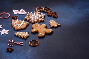 Elements of Christmas decorations, sweets and gingerbread on a wooden cutting board photo