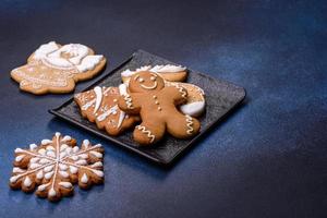 Christmas decorations and gingerbreads on a dark concrete table. Getting ready to celebration photo