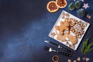 Christmas decorations and gingerbreads on a dark concrete table. Getting ready to celebration photo