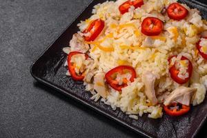 Homemade chinese fried rice with vegetables and a chicken photo