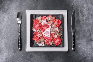 Christmas decorations and gingerbreads on a dark concrete table. Getting ready to celebration photo