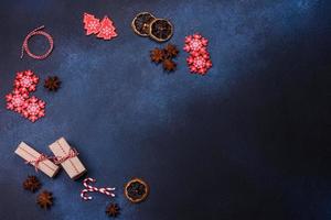 Elements of Christmas decorations, sweets and gingerbread on a wooden cutting board photo