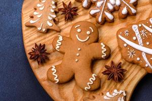 Elements of Christmas decorations, sweets and gingerbread on a wooden cutting board photo