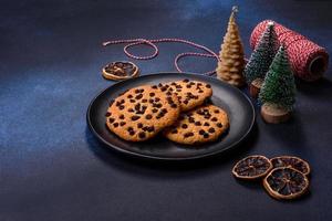 Christmas decorations and gingerbreads on a dark concrete table photo