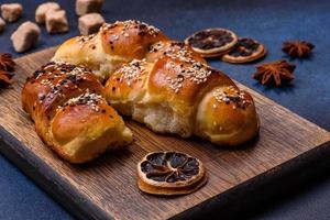 Delicious homemade pastries with apricot jam sprinkled with sesame seeds photo