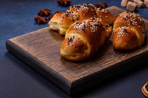 Delicious homemade pastries with apricot jam sprinkled with sesame seeds photo