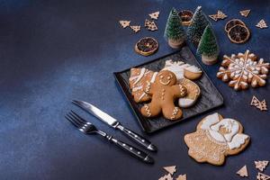 Christmas decorations and gingerbreads on a dark concrete table. Getting ready to celebration photo