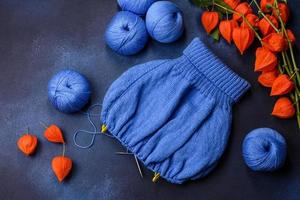 Children's blouse tied with their own hands from blue woolen threads photo