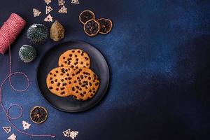 Christmas decorations and gingerbreads on a dark concrete table photo