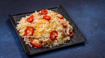 Homemade chinese fried rice with vegetables and a chicken photo