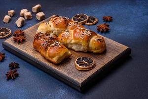Delicious homemade pastries with apricot jam sprinkled with sesame seeds photo