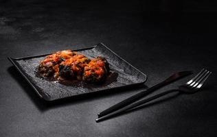 Dolma, stuffed grape leaves with rice and meat on a dark background photo