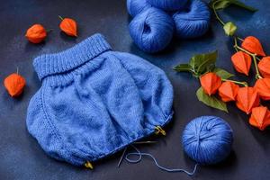 Children's blouse tied with their own hands from blue woolen threads photo