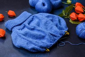 Children's blouse tied with their own hands from blue woolen threads photo