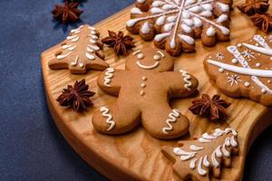 Elements of Christmas decorations, sweets and gingerbread on a wooden cutting board photo