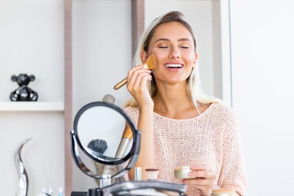 Mujer Que Aplica Maquillaje Pólvora Y Ruboriza Sus Mejillas Foto