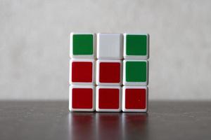 Rubik's cube on the black background. Rubik's Cube was invented by Hungarian architect Erno Rubik in 1974. photo