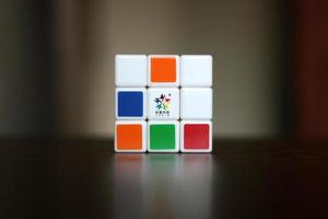 Rubik's cube on the black background. Rubik's Cube was invented by Hungarian architect Erno Rubik in 1974. photo