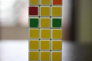 Rubik's cube on the black background. Rubik's Cube was invented by Hungarian architect Erno Rubik in 1974. photo