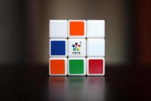 Rubik's cube on the black background. Rubik's Cube was invented by Hungarian architect Erno Rubik in 1974. photo