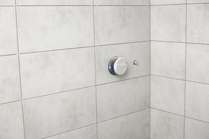 bathroom gray tiles with neat rectangular patterns and built-in shower. Bathroom Tiles Texture. repair photo