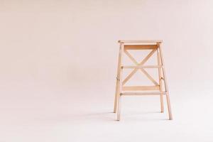 New wooden ladder on the white background. isolated stepladder. Space for text photo