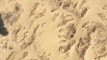 Aerial View of the Textures and Patterns of the Desert Sands. Beautiful landscape . Desert and green bushes photo