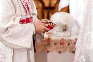 The priest blesses and hold cup the blood of God, wine. Priest celebrate a mass at the church. traditional wedding ceremony. Sacred cup for the wedding ceremony. High quality photo