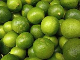 Fresh ripe juicy limes as background photo