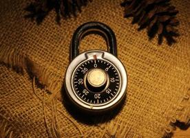 vintage metal steel lock padlock on dark background theme photo