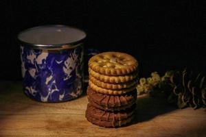 Delicious sweet chocolate cookies on a wooden table with low light photo