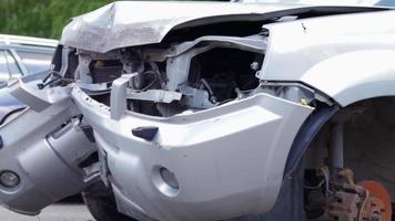 Broken headlights as a result of a collision. Broken gray car after an accident. Car accident concept. Damaged emergency headlight, hood and bumper. Damage to the car body after the accident. video