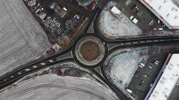 Aerial top down view of a frozen roundabout in winter