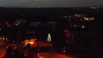 Aerial orbiting view of a Christmas tree in village video