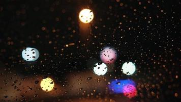 Drops and bokeh lights on the windshield from inside a car and lightning strikes video