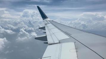 Airplane flight. Wing of an airplane flying above the clouds. video