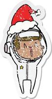 happy distressed sticker cartoon of a astronaut wearing santa hat vector