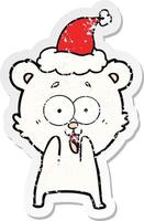 excited teddy bear distressed sticker cartoon of a wearing santa hat vector