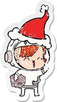 distressed sticker cartoon of a happy spacegirl holding moon rock wearing santa hat vector