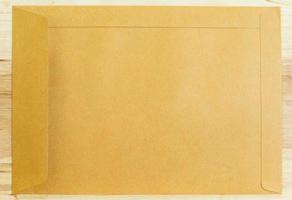 Brown envelope on wood floors photo