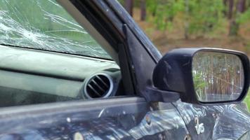 Bullet hole in a car door. Abandoned car with bullet holes. A destroyed vehicle in a war zone in Ukraine. Damaged civilian car. The car was damaged by shrapnel as a result of hostilities. video