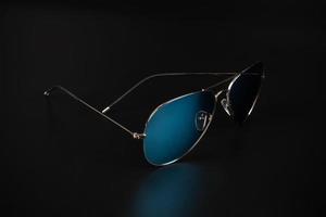 blue polarized sunglasses in dark background photo