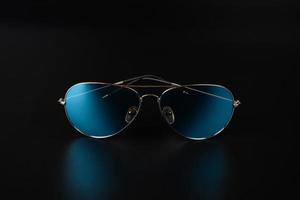 blue polarized sunglasses closeup on dark background photo
