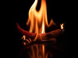 burning hot chili red pepper in dark photo