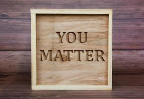 You matter text engraved on wooden frame. inspirational concept photo