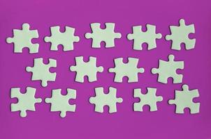 Jigsaw puzzle on purple background with customizable space for text or ideas. Copy space photo