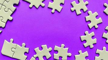 Jigsaw puzzle on purple background with customizable space for text or ideas. Copy space photo