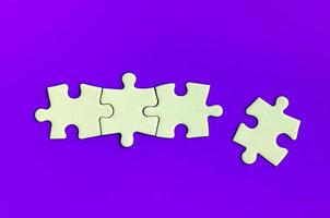 Jigsaw puzzle on purple background with customizable space for text or ideas. Copy space photo